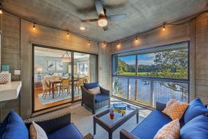 a living room with a blue couch and a large window at 4922 Turtle Point in Kiawah Island