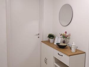 a bathroom with a vanity with a mirror on the wall at Garibaldi Apartment Sanremo La Piazzetta in Sanremo