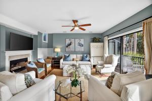 a living room with white furniture and a ceiling fan at 4922 Turtle Point in Kiawah Island