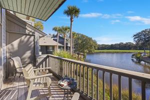 a balcony with chairs and a view of a river at 4922 Turtle Point in Kiawah Island