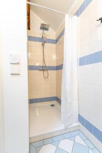a bathroom with a shower with a white shower curtain at Black Apartment - Large Spacious One Bedroom Penthouse Loft in Baden-Baden +12 photos