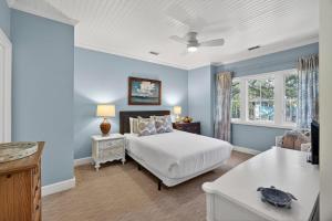 a blue bedroom with a bed and a window at 4922 Turtle Point in Kiawah Island