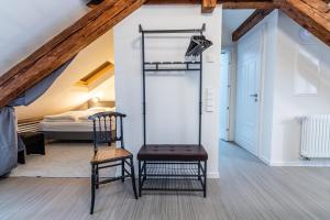 a room with a ladder and a chair and a bed at Black Apartment - Large Spacious One Bedroom Penthouse Loft in Baden-Baden
