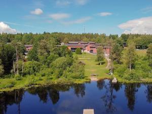 an aerial view of a house next to a lake at Sørmarka Konferansehotell in Siggerud
