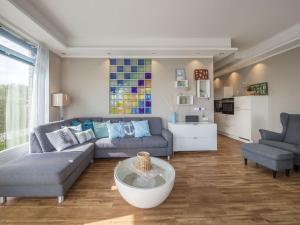 a living room with a couch and a table at Strandburg "Aquamarin" 01 a in Burgtiefe auf Fehmarn 