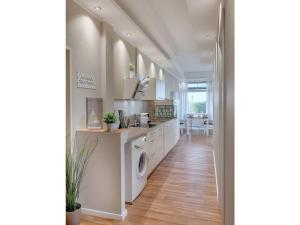 a kitchen with a washer and dryer in a room at Strandburg "Aquamarin" 01 a in Burgtiefe auf Fehmarn 
