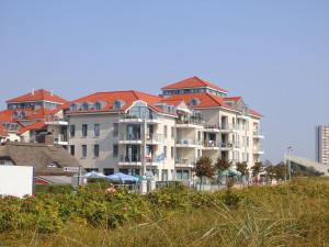 a large building with red roofs on a beach at Strandburg "Tiefblau" 01 b in Burgtiefe auf Fehmarn 
