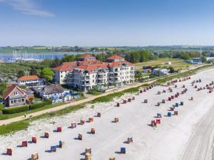 an aerial view of a beach with chairs and umbrellas at Strandburg "Azurblau" 01 c in Burgtiefe auf Fehmarn  +12 photos