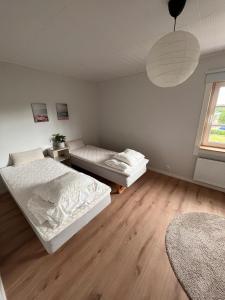 a bedroom with two beds and a window at Cozy big villa in Hanko in Hanko