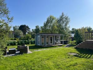 a tiny house in the middle of a yard at Cozy big villa in Hanko in Hanko
