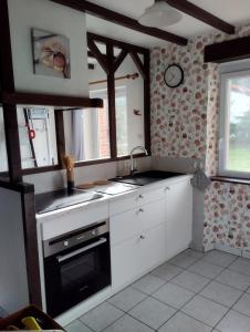 a kitchen with a sink and a stove at Gîte Tucolet in Hinx