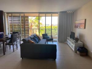 a living room with a couch and a dining room at Salgados Retreat in Bicas