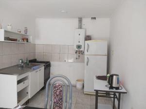 a kitchen with a white refrigerator and a sink at Patio Escondido in Paraná