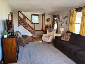 a living room with a couch and a chair at Comfortable Craftsman Getaway in Lancaster
