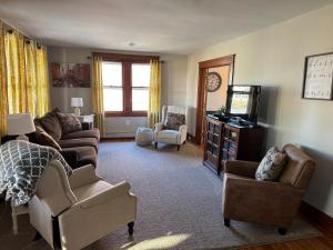 a living room with a couch and chairs and a television at Comfortable Craftsman Getaway in Lancaster +24 photos