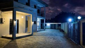 an empty street at night with a building at Velo Apartments in Kribi in Kribi