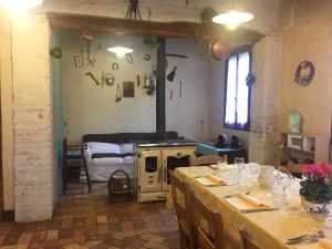 a kitchen with a table and a stove in a room at La Prediletta in Motta di Livenza