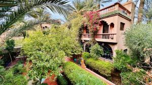 a house with a lot of plants and trees at Chez Ali Zagora Authentic Hotel Restaurant and Desert Excursions in Zagora