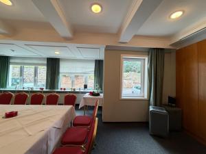 a room with a table and chairs and a window at Wagners Hotel im Thüringer Wald in Tabarz +12 photos