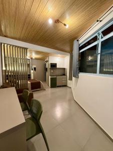 a living room with a table and chairs and a kitchen at Hotel Priskar in Ouro Preto +34 photos