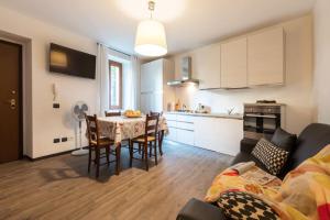 a kitchen and living room with a table and chairs at Loppia Bay View Apartment in Bellagio