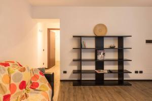 a living room with a book shelf and a couch at Loppia Bay View Apartment in Bellagio