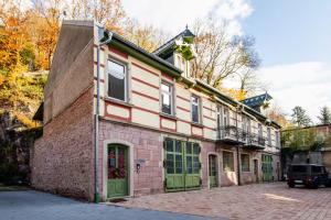 a building with green doors on the side of it at Black Apartment - Large Spacious One Bedroom Penthouse Loft in Baden-Baden