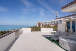 a balcony of a house with a view of the ocean at Una Terrazza sul Mare The Lighthouse in Paola