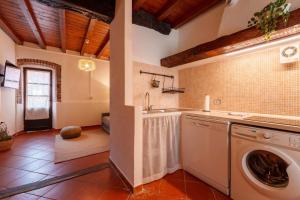 a kitchen with a washing machine and a sink at Beach Lake Apartment in Bellagio