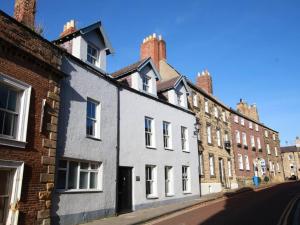 a row of brick buildings on a street at 1BR Private Lodge inc Sofa Bed in Alnwick