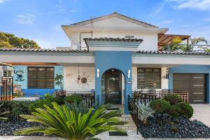 a house with a blue and white at Gaviota del Mar with private pool in Rincon