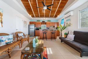a living room with a couch and a table at Gaviota del Mar with private pool in Rincon