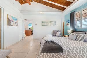 a bedroom with a bed and a couch at Gaviota del Mar with private pool in Rincon +21 photos