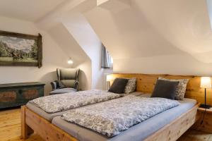 a bedroom with a bed and a chair at Rinntaverne in Palfau