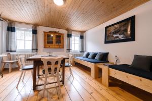 a living room with a table and a couch at Rinntaverne in Palfau +49 photos