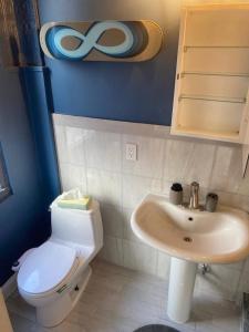 a bathroom with a toilet and a sink at No7-Corner Studio in Bridgeport