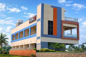 a building with a sign on the side of it at Aarna Beach Stay in Vadarevu