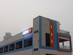 a building with a sign on top of it at Aarna Beach Stay in Vadarevu