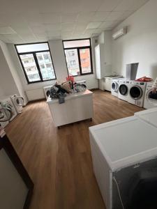 a large room with washing machines and a kitchen at Resident aparments two bed with balcony in Bucharest +2 photos