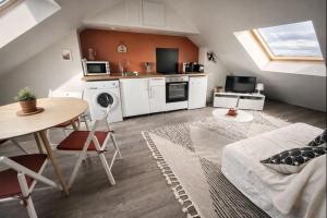 a living room with a table and a kitchen at Le cocon San Francisco in Tours +14 photos