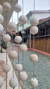 a group of white hats hanging from a pole at Villamar Pousada in Morro de São Paulo