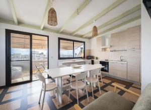 a kitchen and dining room with a table and chairs at Fronte Mare in Centro a Torre Lapillo in Torre Lapillo