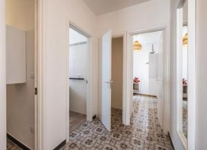 a hallway with white walls and a hallway with a door at Fronte Mare in Centro a Torre Lapillo in Torre Lapillo +27 photos