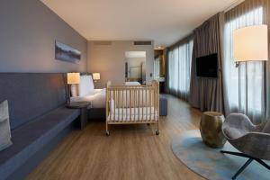 a hotel room with a crib and a bedroom at Radisson Blu Hotel, Lucerne in Lucerne +285 photos