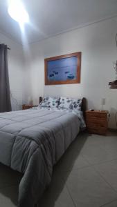 a bedroom with a bed and a painting on the wall at Ampolias rooms Messolonghi in Missolonghi