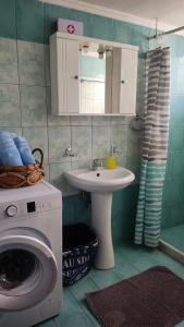 a bathroom with a washing machine and a sink at Ampolias rooms Messolonghi in Missolonghi