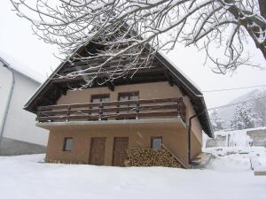 a house with snow on the roof of it at Planinska kuća Kupres in Kupres