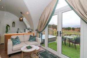 a living room with a couch and a table at Crofters Suite in Acharacle