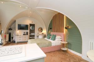 a bedroom with a bed in an arched room at Crofters Suite in Acharacle