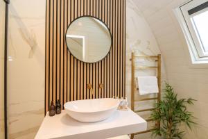 a bathroom with a sink and a mirror at Crofters Suite in Acharacle +17 photos